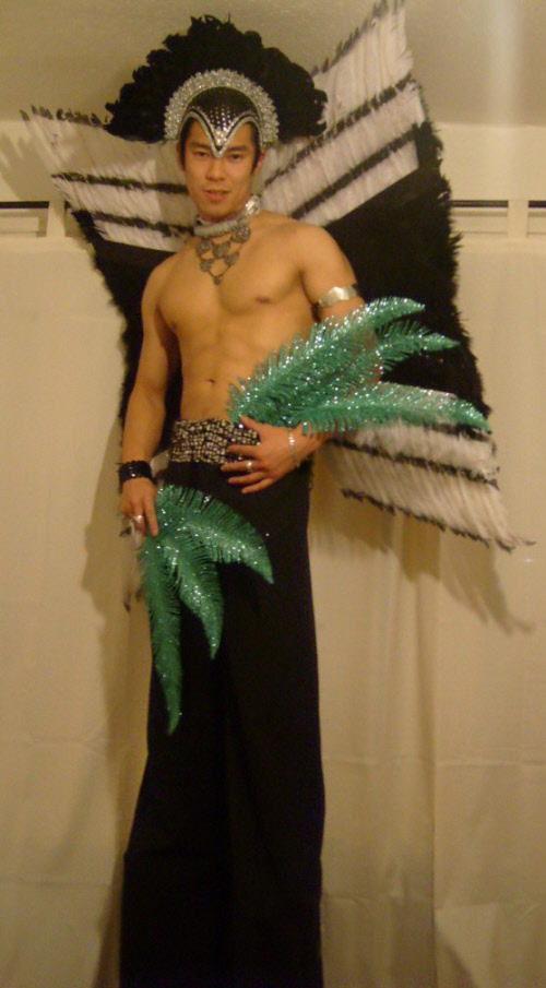 Male stiltwalker with feathers