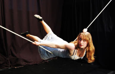 Alice lying across the slack rope